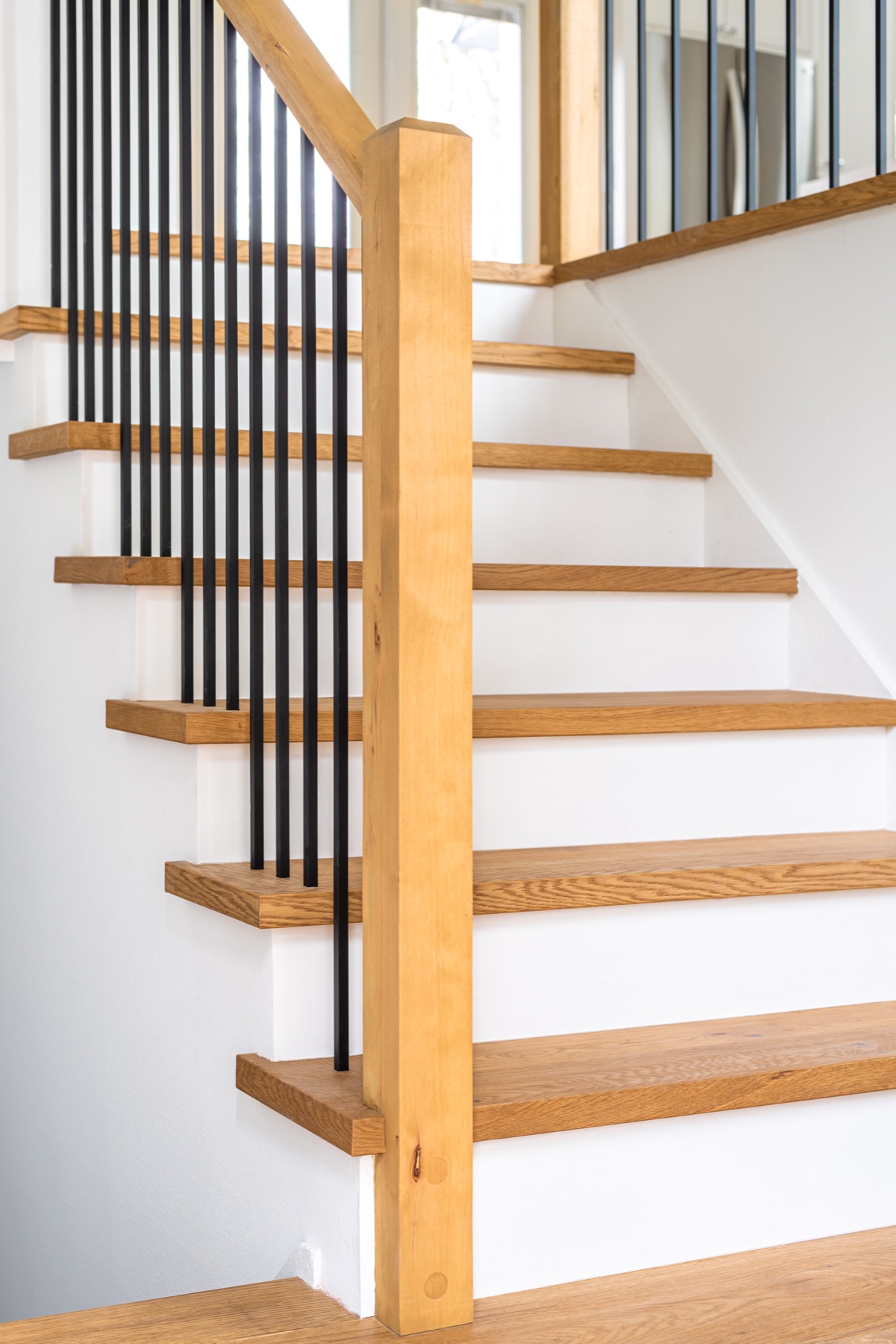 White oak open staircase with black metal rails